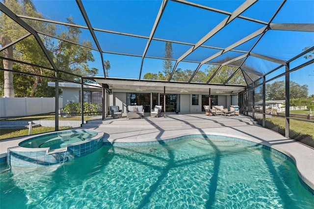 view of pool with glass enclosure, an outdoor hangout area, fence, a pool with connected hot tub, and a patio area