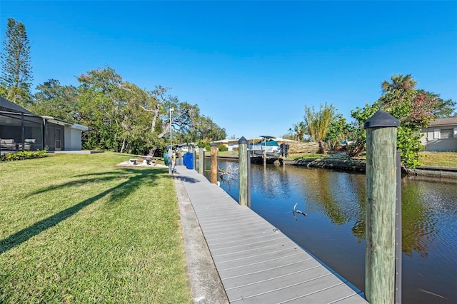 dock area featuring a lawn and a water view