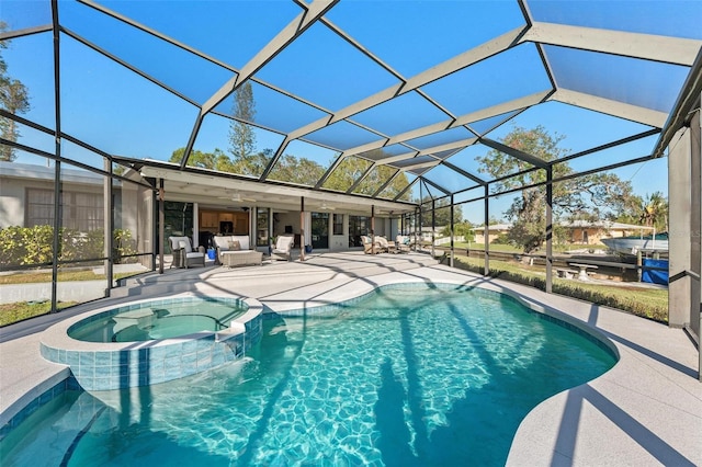 view of swimming pool featuring a lanai, ceiling fan, a patio area, and an in ground hot tub