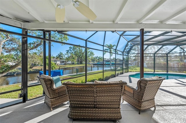 sunroom with a water view and a ceiling fan