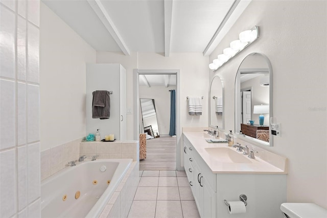 bathroom featuring vanity, a relaxing tiled tub, and tile patterned floors