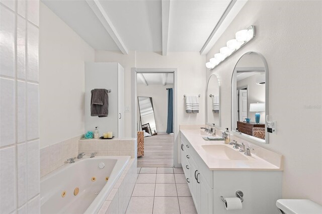 608 69th Ave W, Bradenton, FL 34207 - ensuite bathroom featuring a jetted tub, double vanity, beamed ceiling, and tile patterned flooring