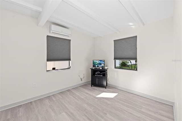 unfurnished living room with a wall mounted air conditioner, light hardwood / wood-style floors, and beamed ceiling