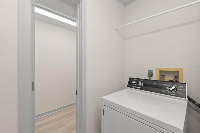 laundry room with washer / dryer and light wood-type flooring