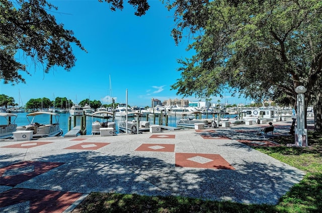 surrounding community with a water view and a dock