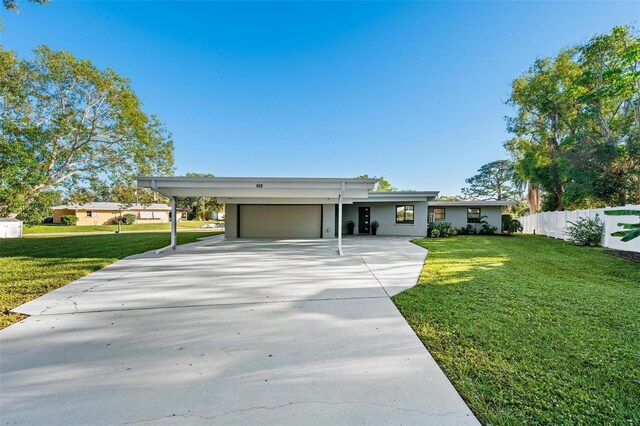 608 69th Ave W, Bradenton, FL 34207 - view of front facade with a garage, concrete driveway, and stucco siding
