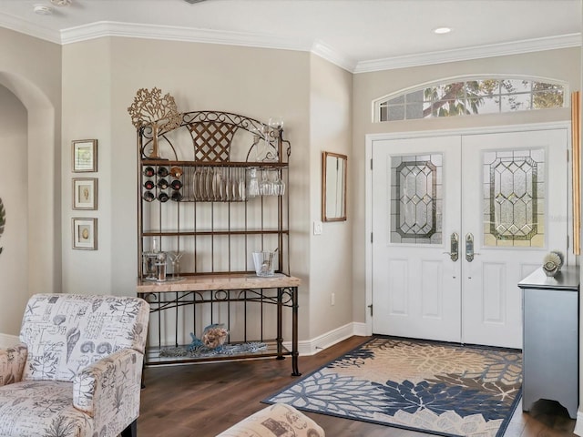 entryway with french doors, dark hardwood / wood-style floors, and ornamental molding