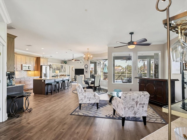 living room featuring ornamental molding, dark wood-type flooring, and a chandelier