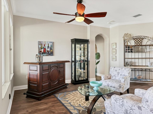 sitting room with crown molding, ceiling fan, and dark wood-type flooring