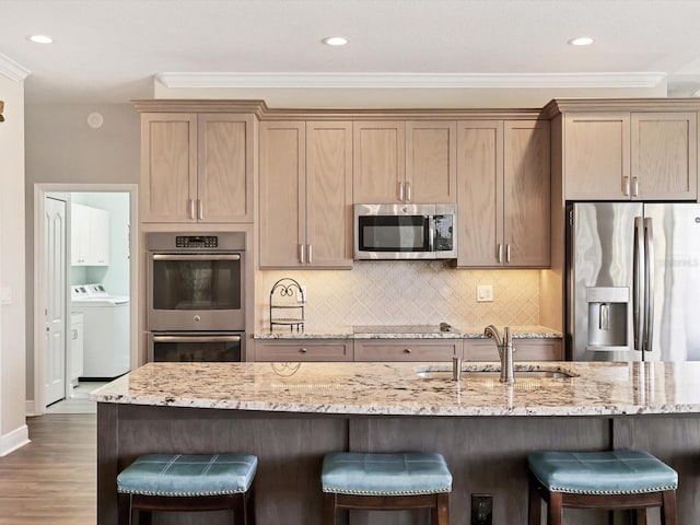 kitchen featuring dark wood-type flooring, crown molding, sink, appliances with stainless steel finishes, and light stone counters