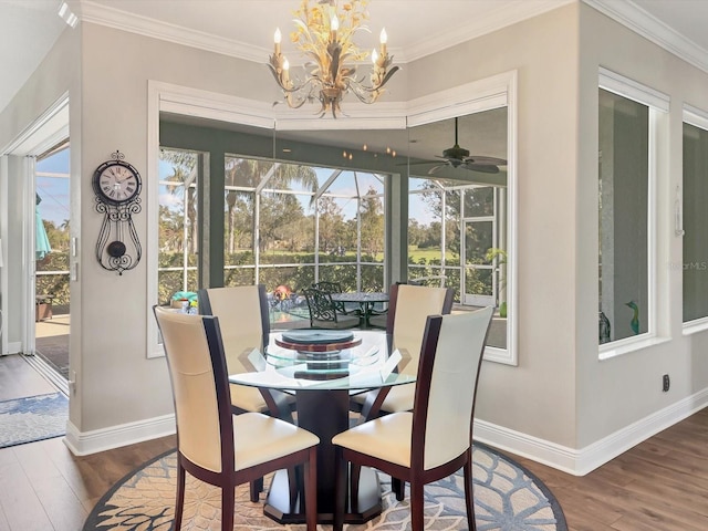 dining room featuring hardwood / wood-style floors, ceiling fan with notable chandelier, and crown molding