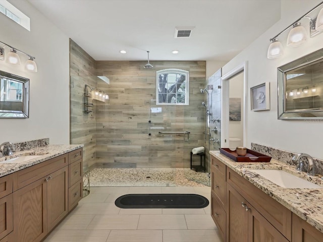 bathroom with vanity, tile patterned floors, and a shower with door