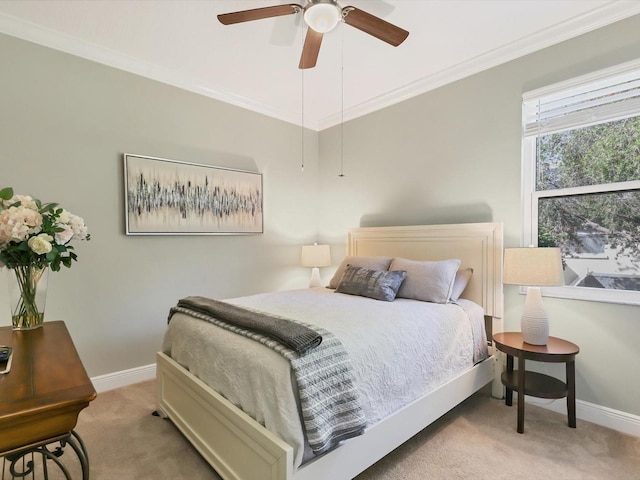 bedroom featuring ceiling fan, crown molding, and light carpet