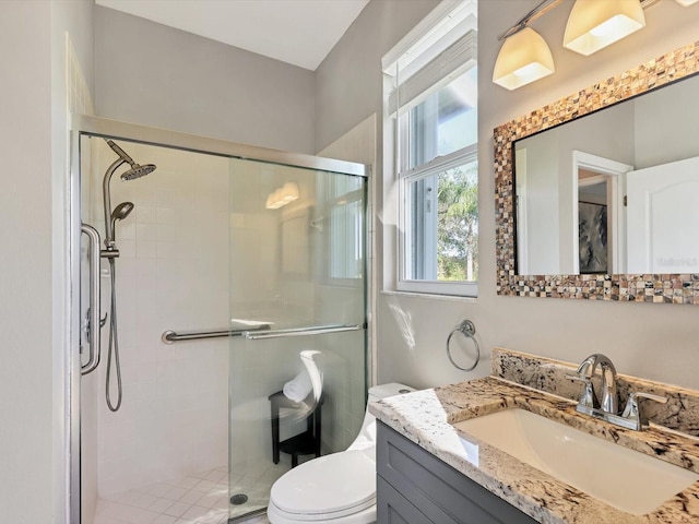 bathroom with vanity, an enclosed shower, and toilet