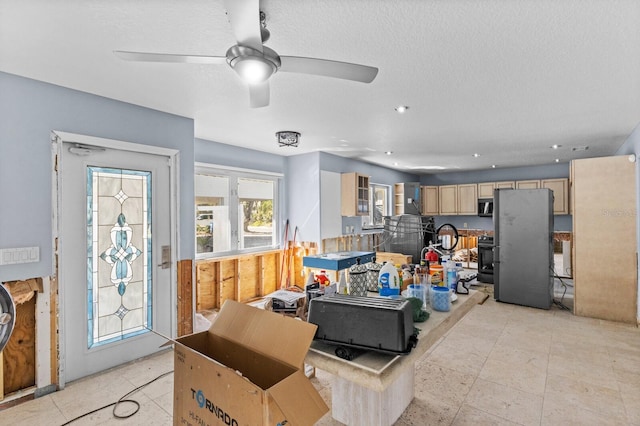 interior space featuring ceiling fan and a textured ceiling