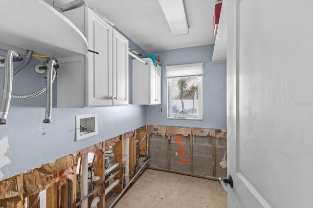 clothes washing area featuring washer hookup and cabinets