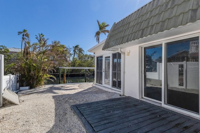 wooden deck featuring a water view