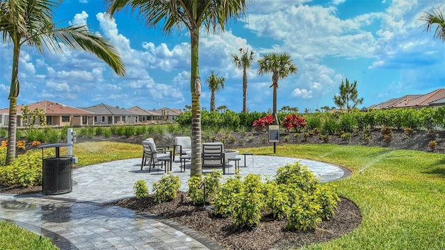 surrounding community with a lawn and a patio