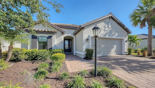 mediterranean / spanish-style home with a garage