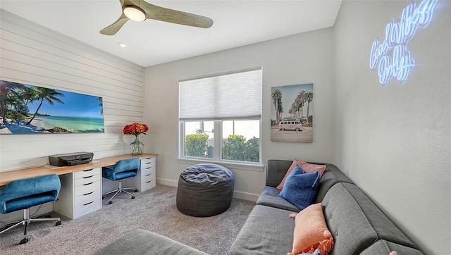 carpeted office space featuring ceiling fan