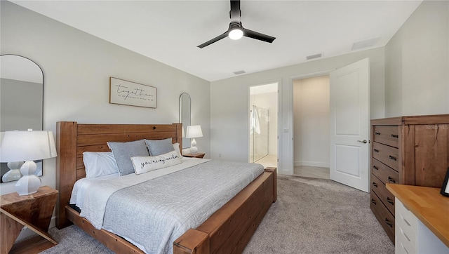 bedroom featuring connected bathroom, ceiling fan, and light carpet