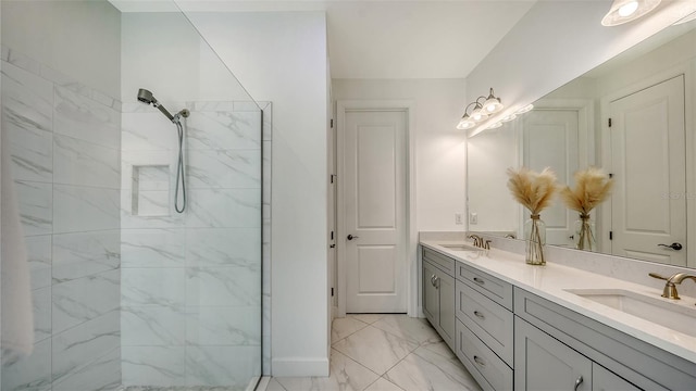 bathroom featuring tiled shower and vanity