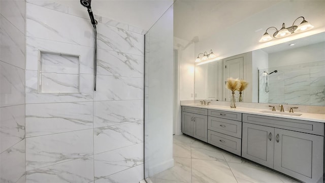 bathroom with a tile shower and vanity