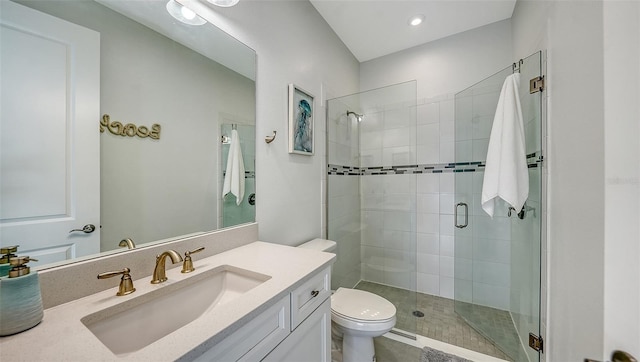 bathroom with tile patterned flooring, vanity, toilet, and walk in shower