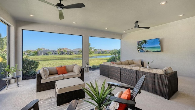 sunroom featuring a wealth of natural light and ceiling fan