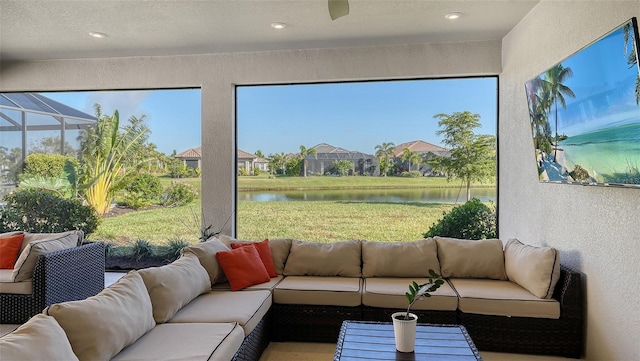 sunroom / solarium featuring a water view