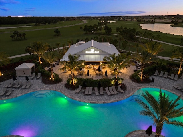 pool at dusk with a water view