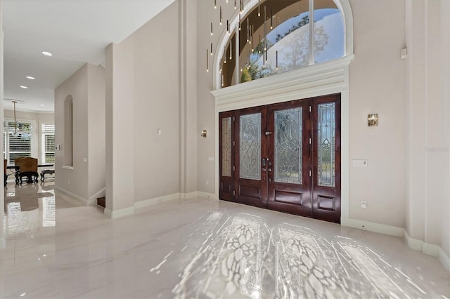 foyer with french doors and a towering ceiling