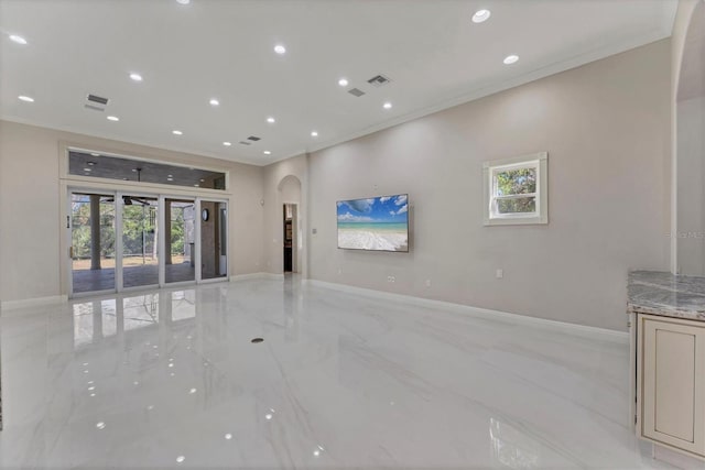 unfurnished living room featuring ornamental molding