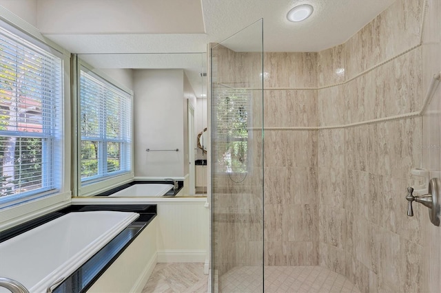 bathroom featuring separate shower and tub