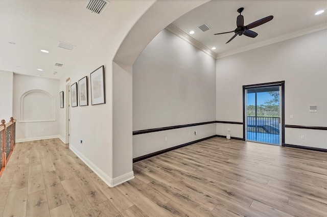 unfurnished room featuring light hardwood / wood-style flooring, ornamental molding, and ceiling fan