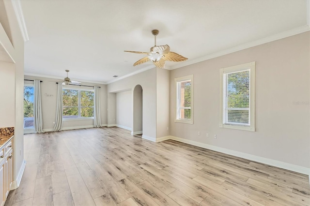 unfurnished living room with ceiling fan, ornamental molding, and light hardwood / wood-style floors