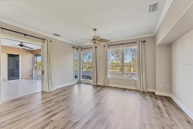 spare room featuring ceiling fan, a healthy amount of sunlight, and light hardwood / wood-style floors