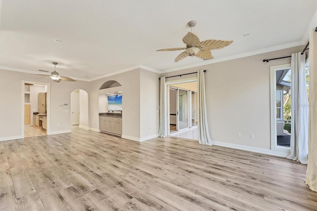 unfurnished living room with crown molding, ceiling fan, and light hardwood / wood-style floors