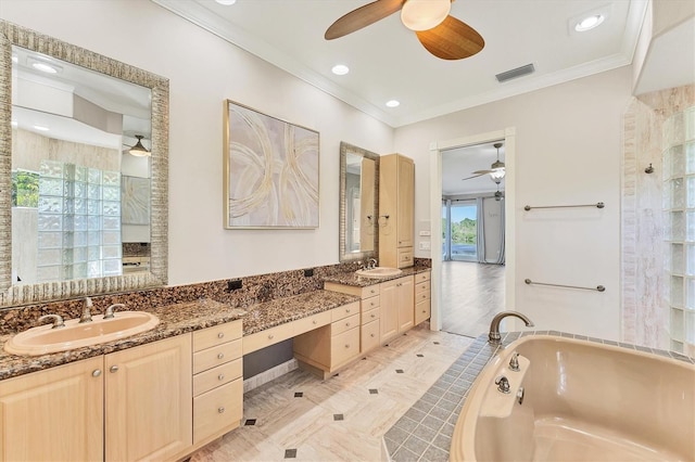 bathroom featuring crown molding, ceiling fan, vanity, and a washtub