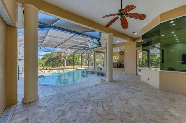 view of pool featuring a lanai, a patio area, an outdoor bar, and ceiling fan