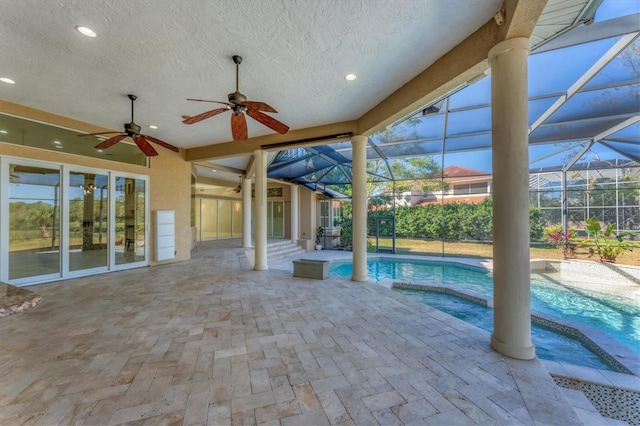 view of pool with an in ground hot tub, a lanai, ceiling fan, and a patio