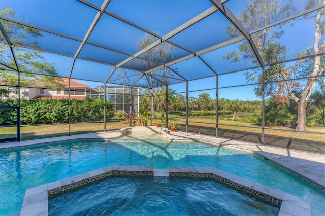 view of pool with an in ground hot tub, a lanai, and a patio area