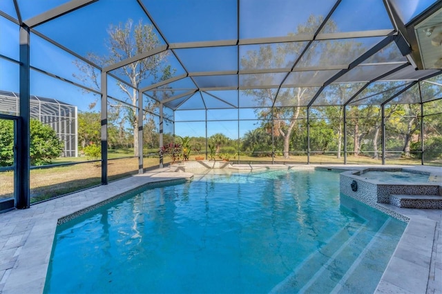 view of pool with a lanai, a patio, and an in ground hot tub