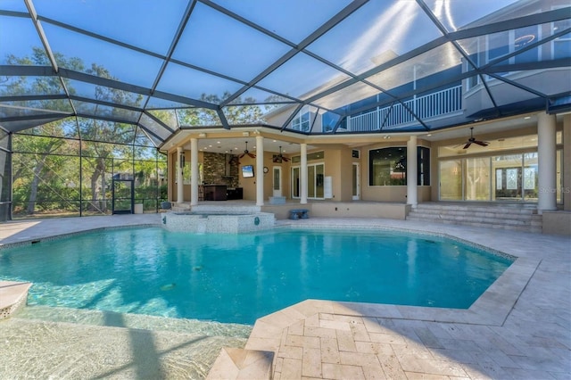 view of swimming pool featuring a lanai, a patio area, ceiling fan, and exterior kitchen