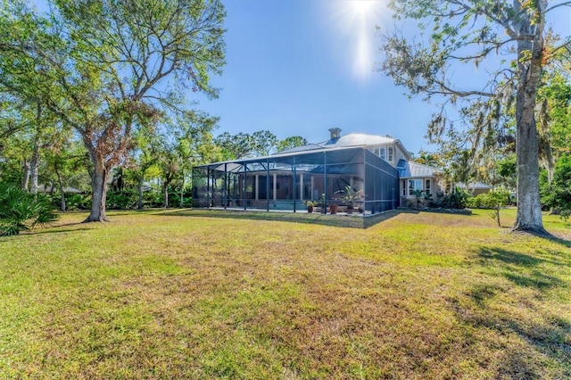 view of yard with glass enclosure