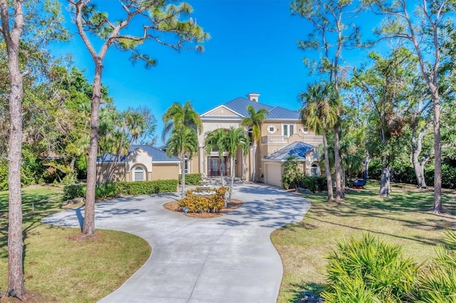 mediterranean / spanish home with a front yard