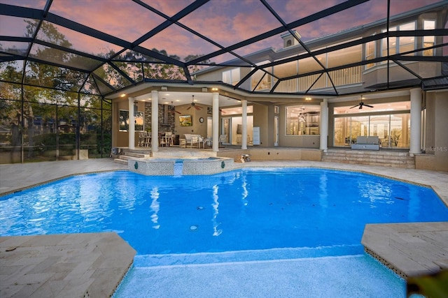 outdoor pool with an in ground hot tub, a ceiling fan, exterior kitchen, and a patio