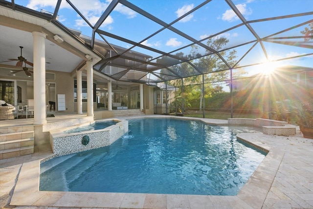 view of pool featuring ceiling fan, a patio, a lanai, and a pool with connected hot tub