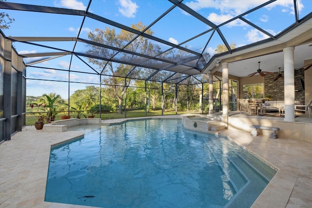 view of swimming pool with a ceiling fan, a lanai, a patio area, and a pool with connected hot tub