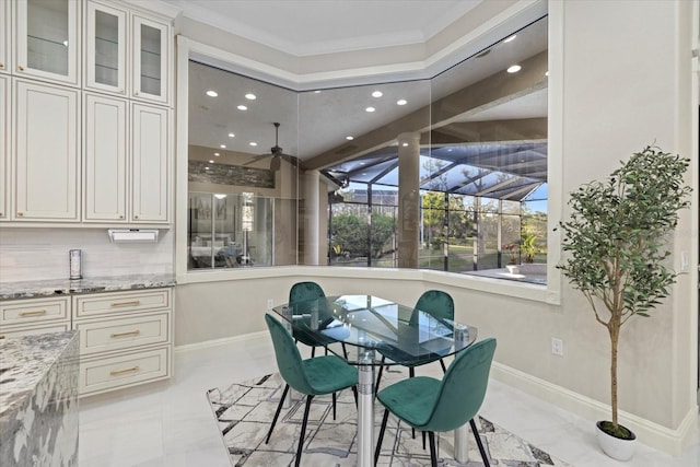 dining area with recessed lighting, a sunroom, crown molding, and baseboards